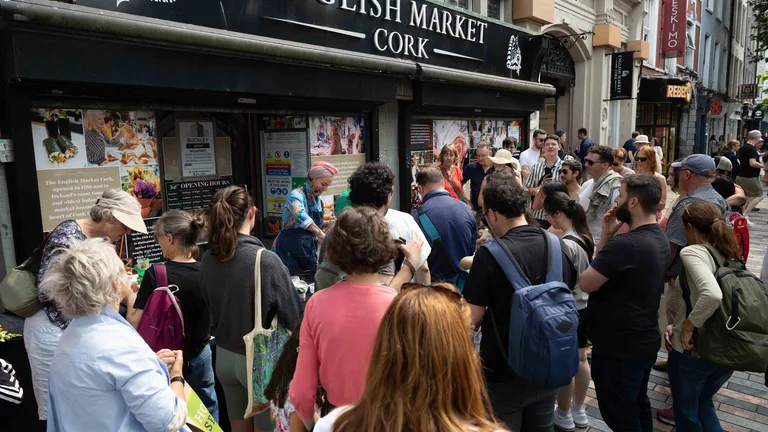 A group of people standing outside a store