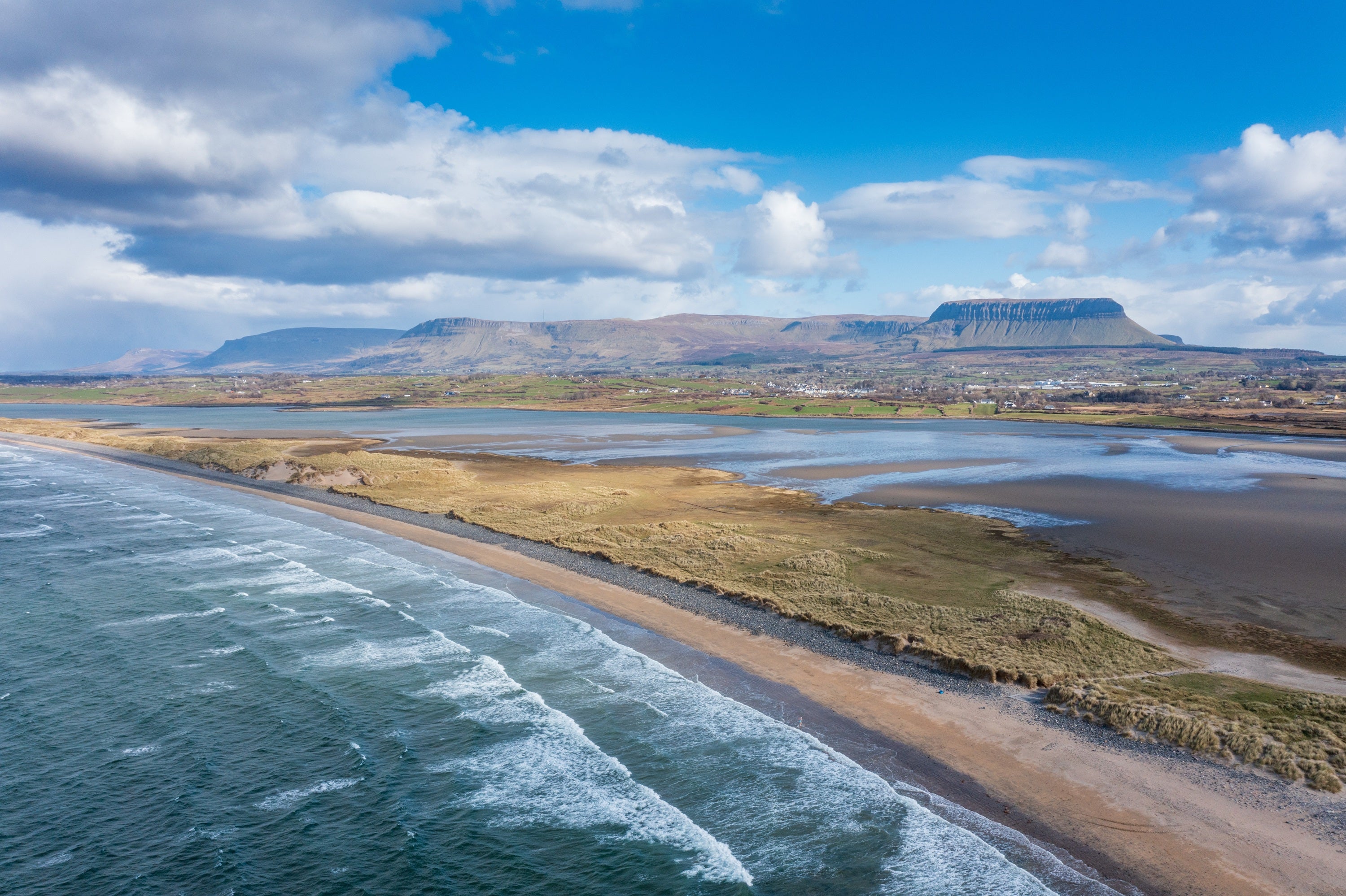 Aerial view of beach and mountains in the background