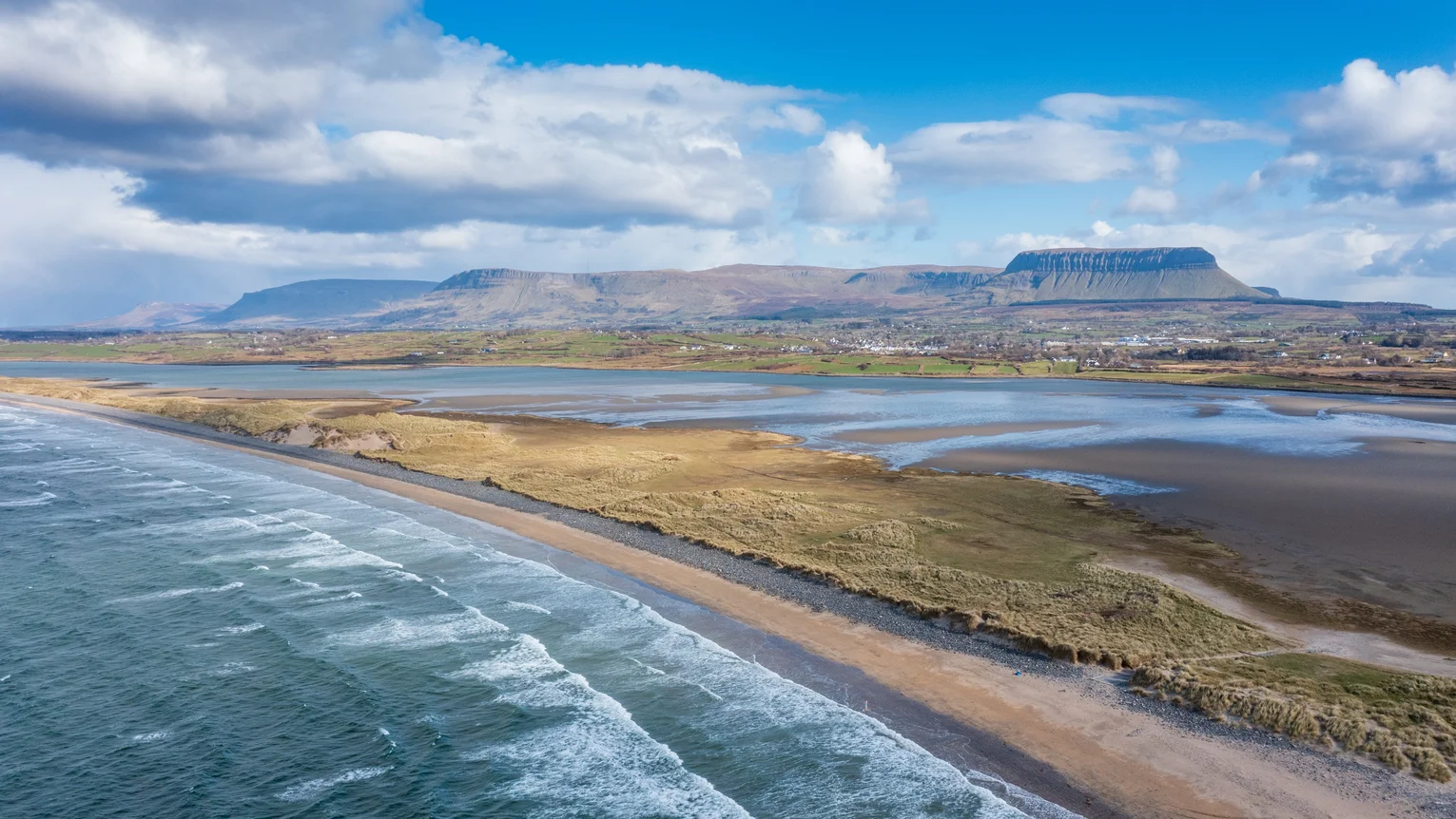 Aerial view of beach and mountains in the background