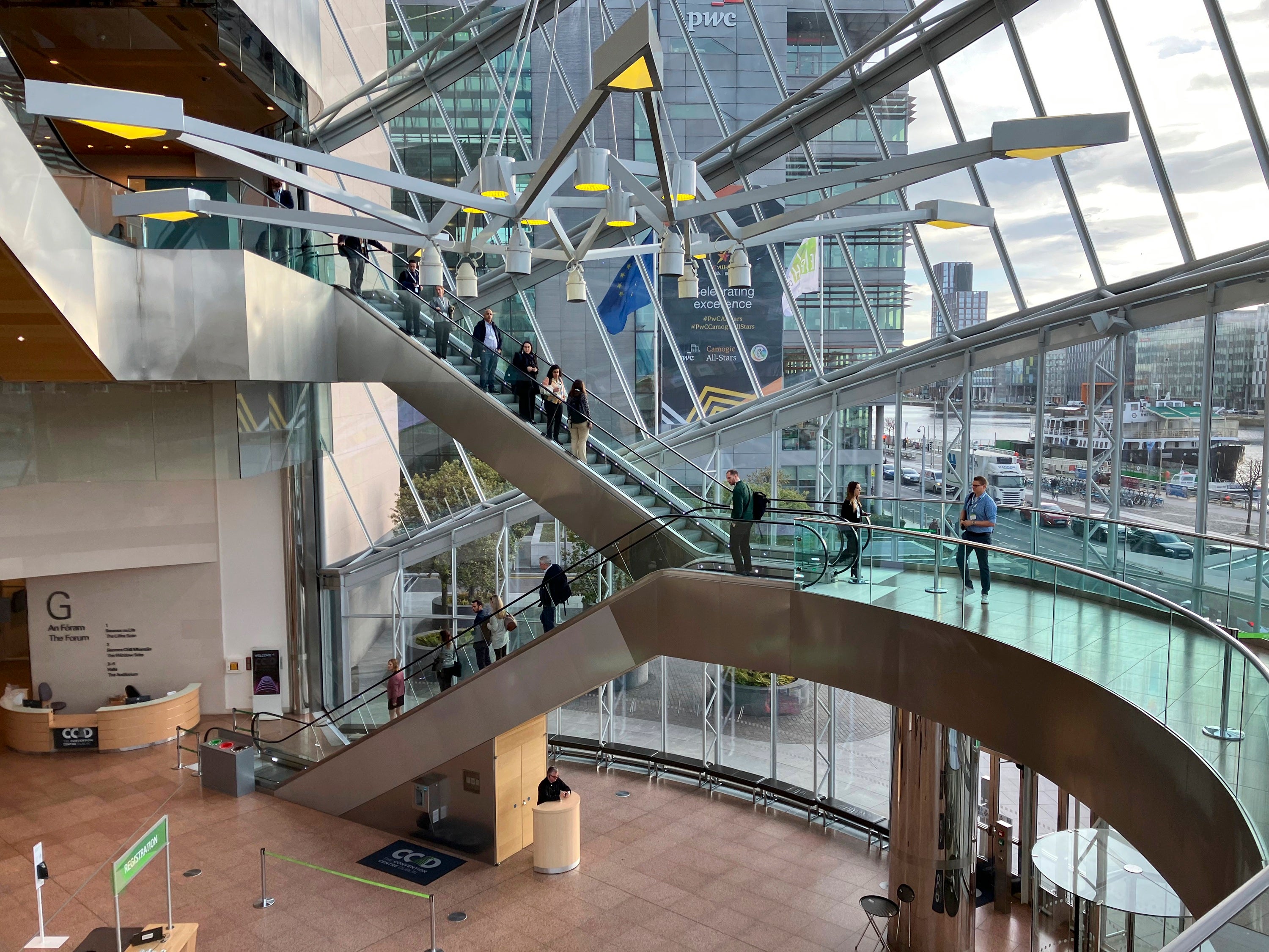 A group of people on escalators in a conference building