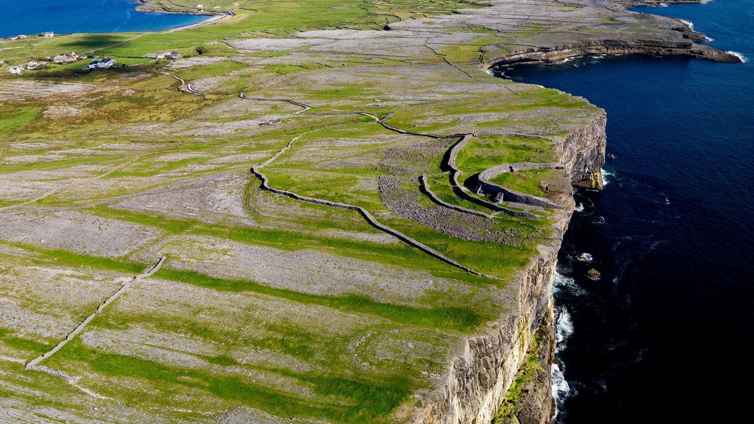 An aerial view of a large land with a body of water