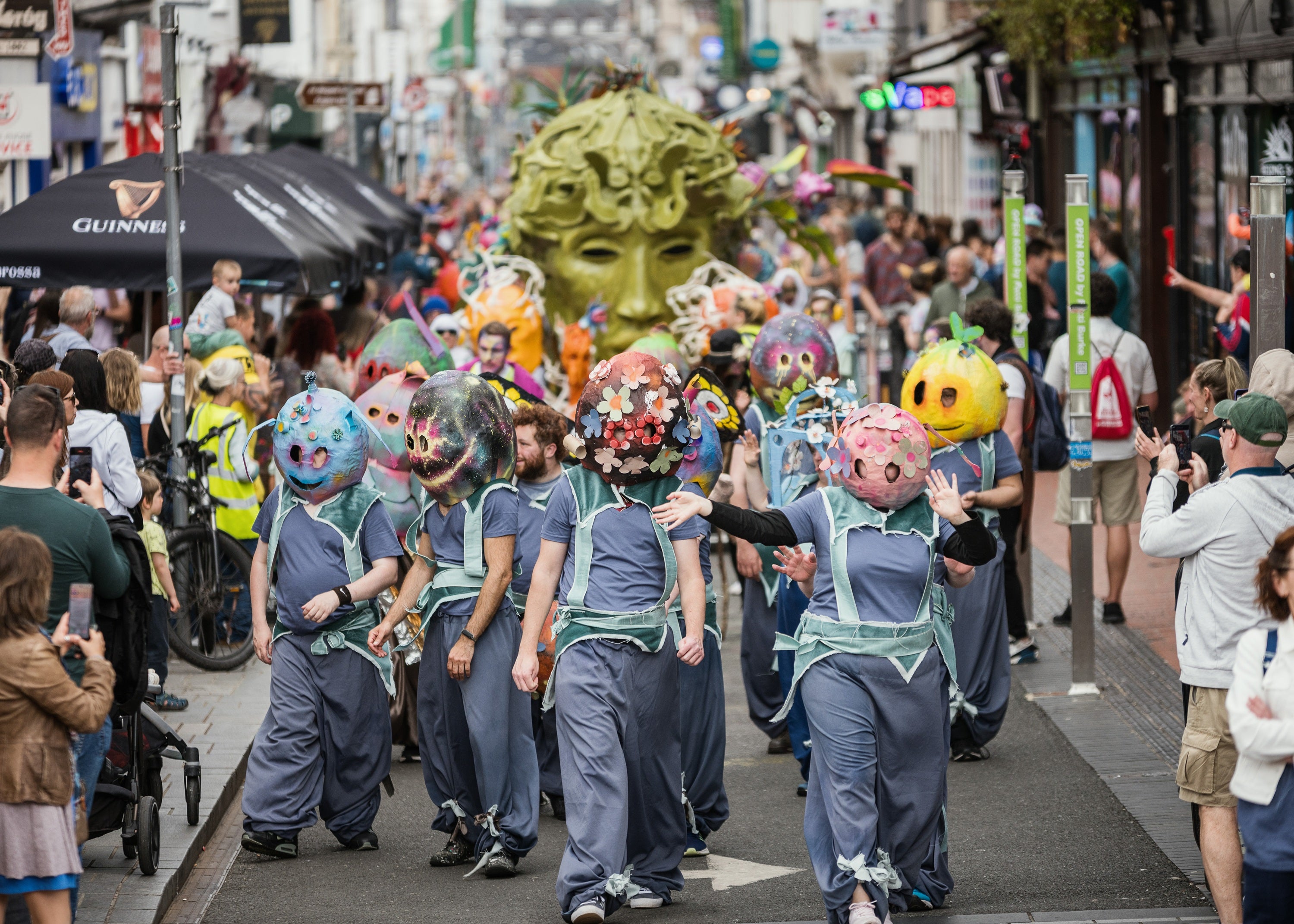 A group of performers wearing masks in a parade