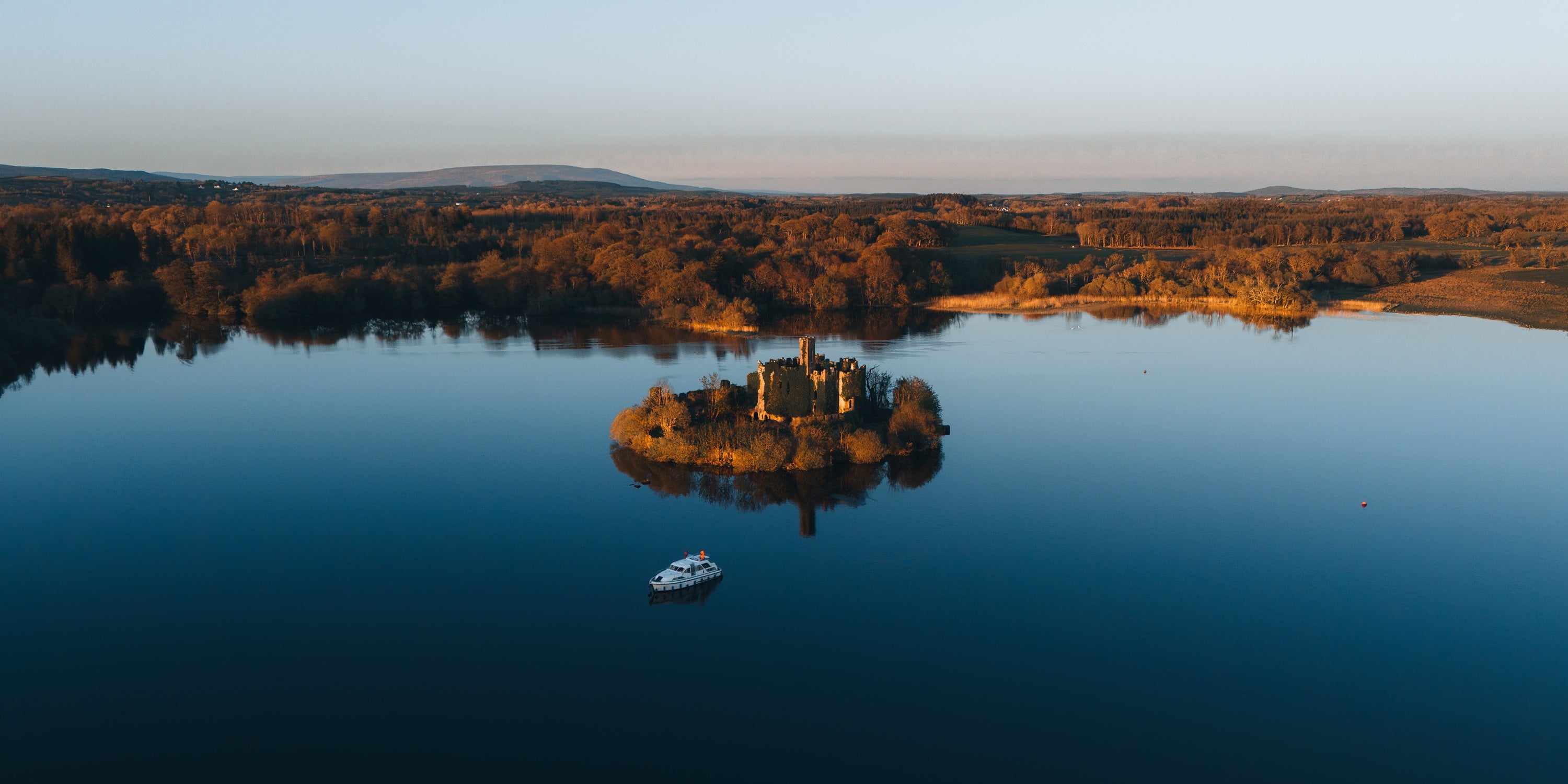 An island with a castle in the middle of a lake