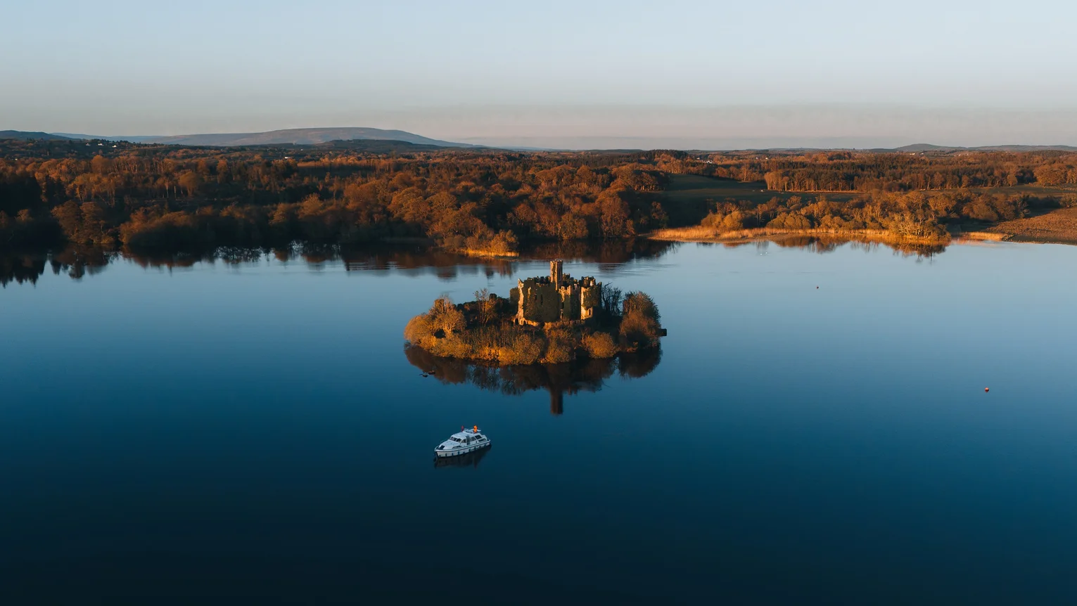 An island with a castle in the middle of a lake