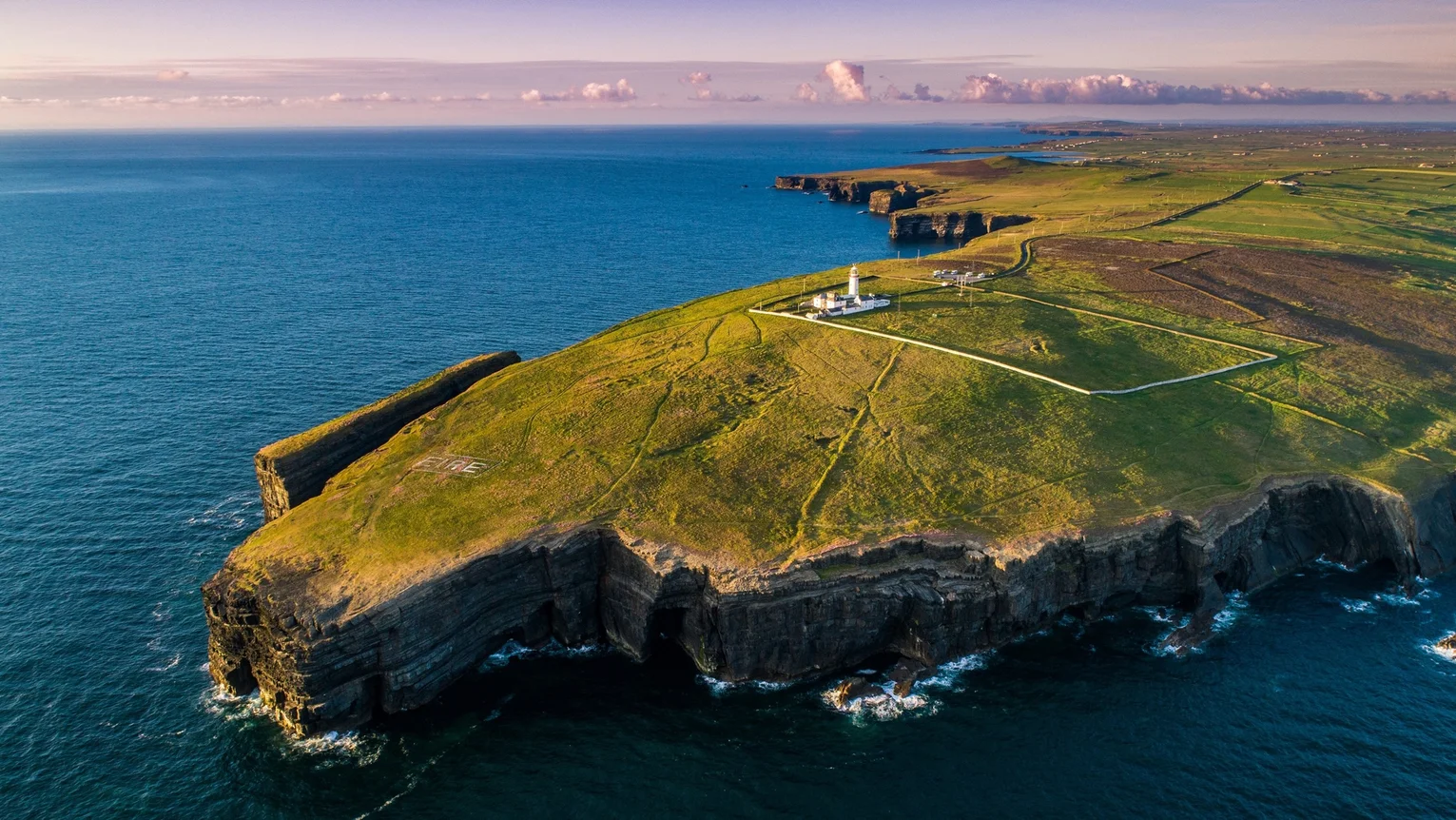 A lighthouse on a green island