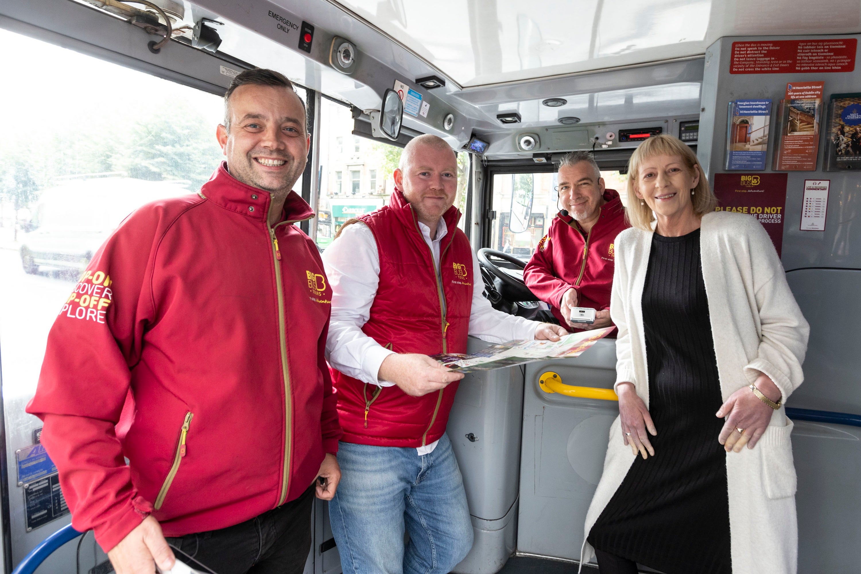 A group of people standing in a bus