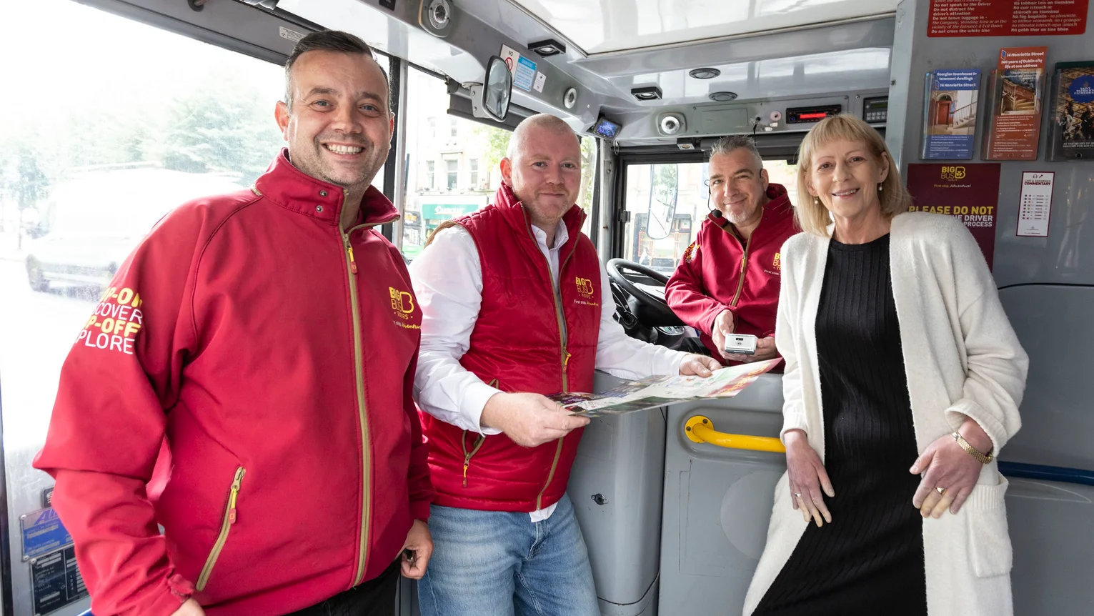 A group of people standing in a bus