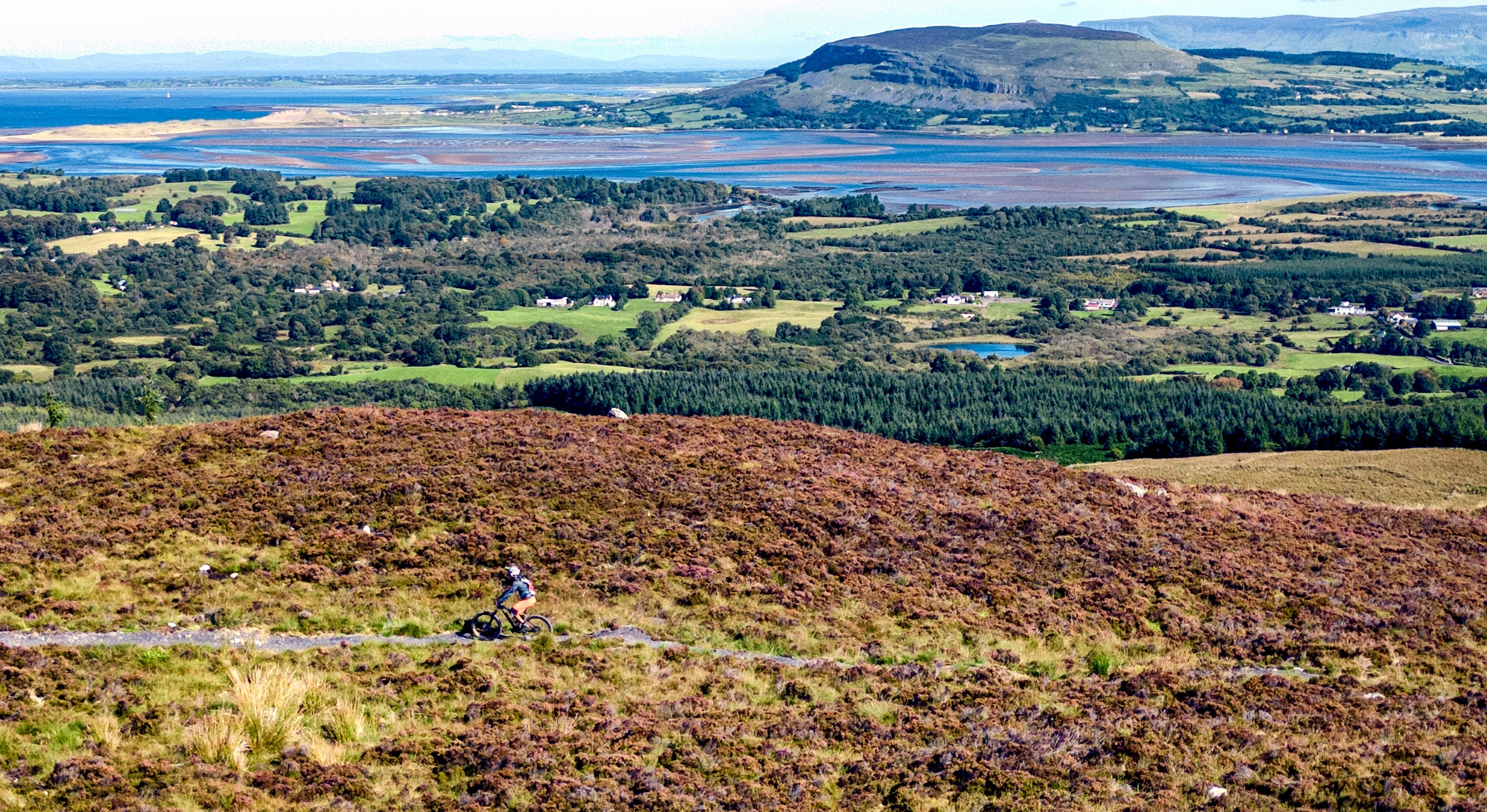A person riding a bike on a hill
