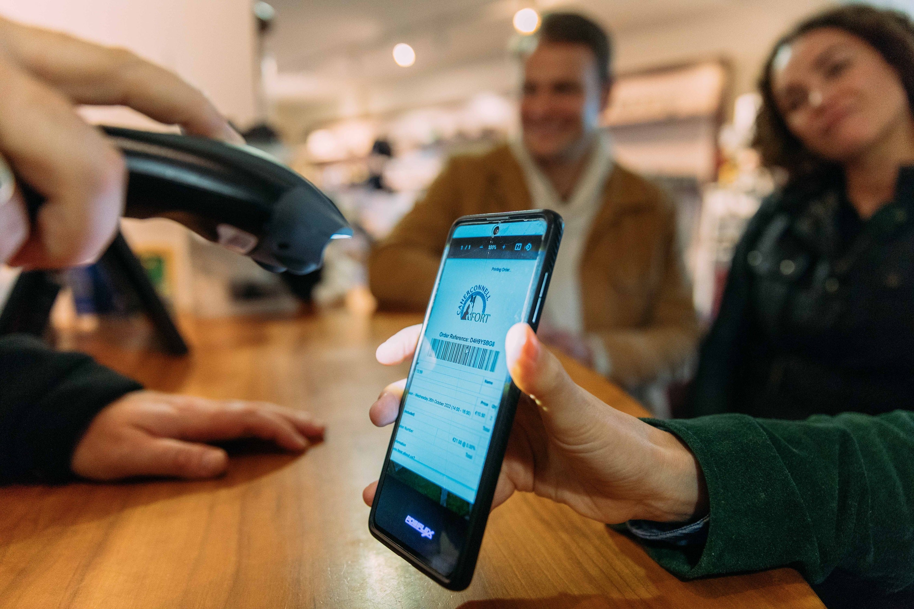 A person scanning a barcode on a phone