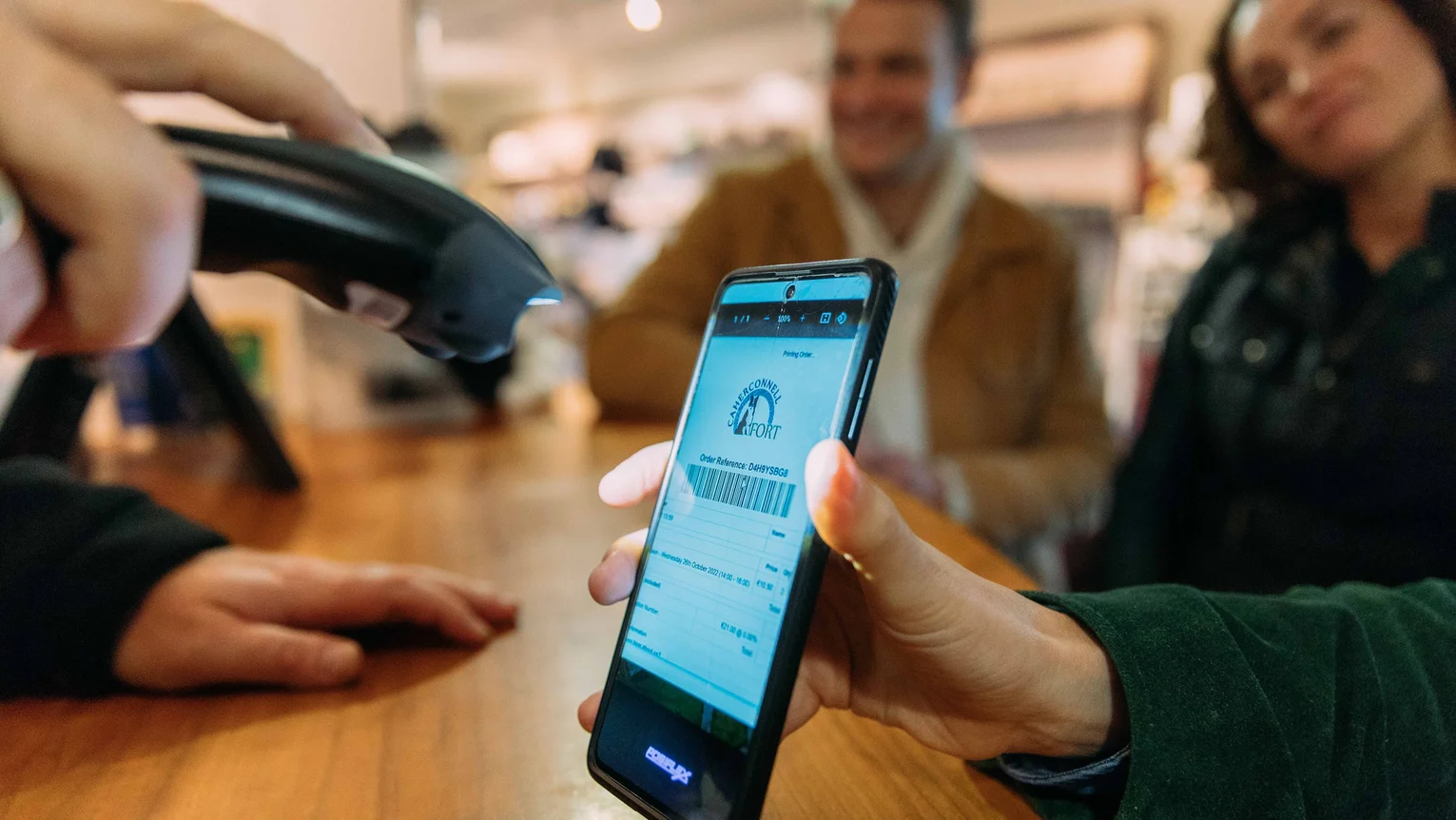 A person scanning a barcode on a phone