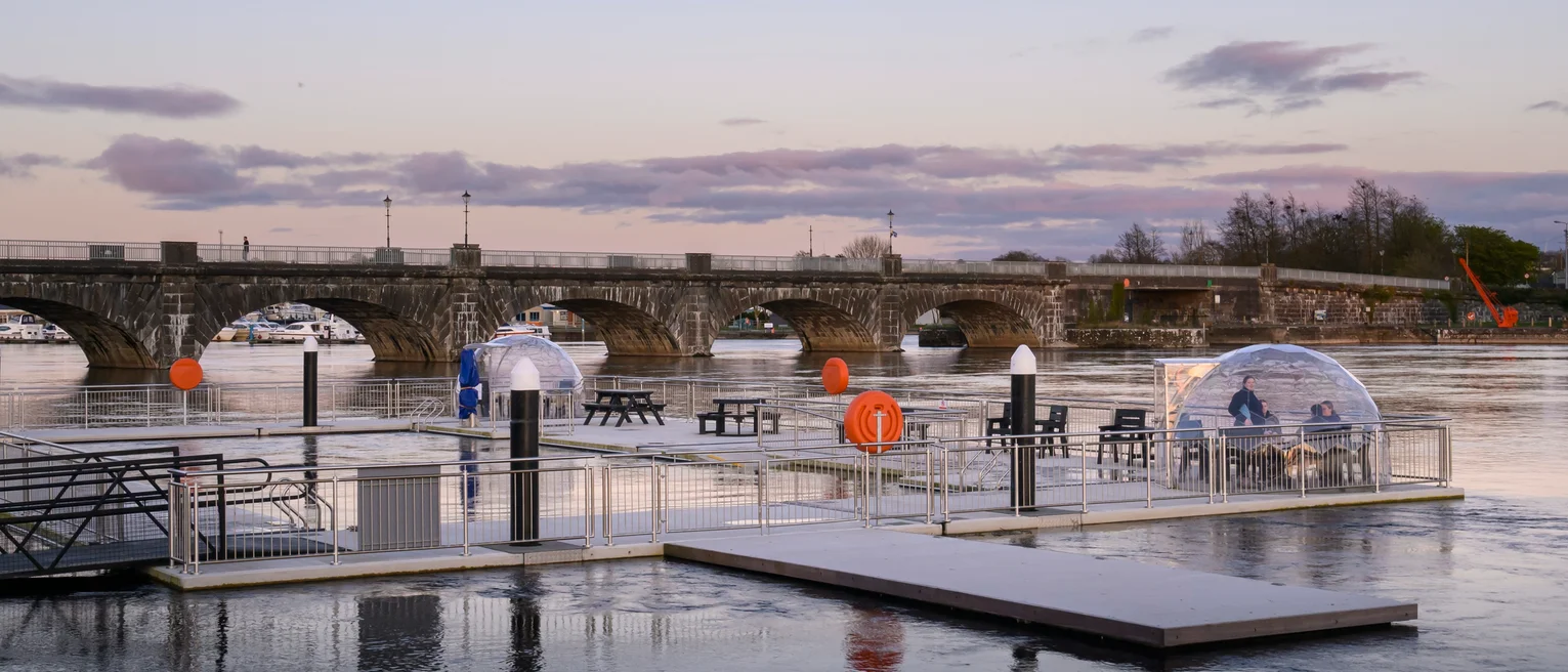 A floating outdoor swimming pool and a bridge in the background