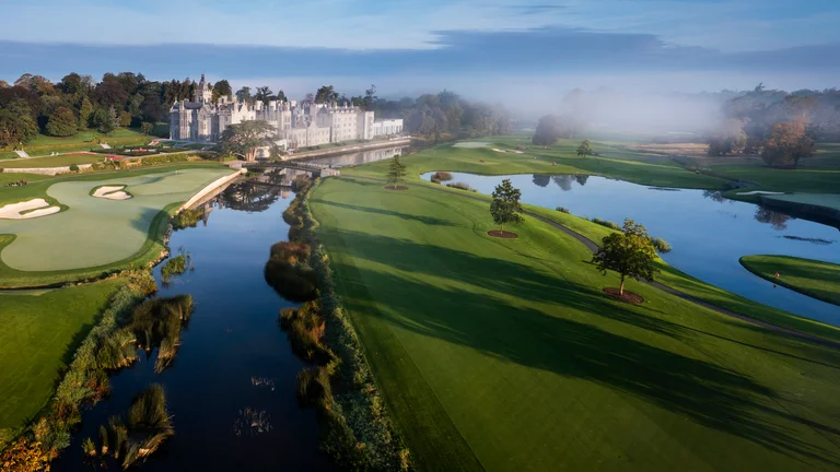 A golf course with a castle in the background