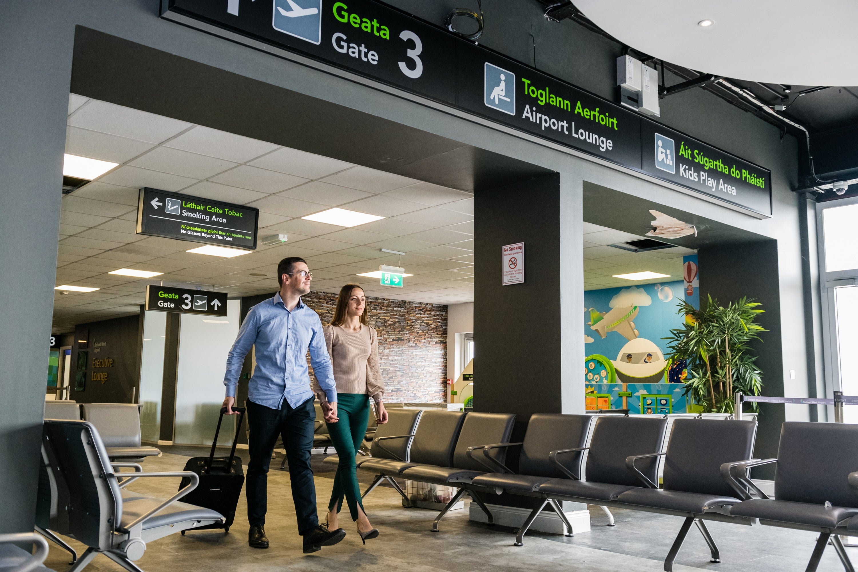 A man and woman walking in an airport terminal