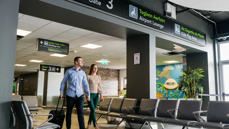 A man and woman walking in an airport terminal