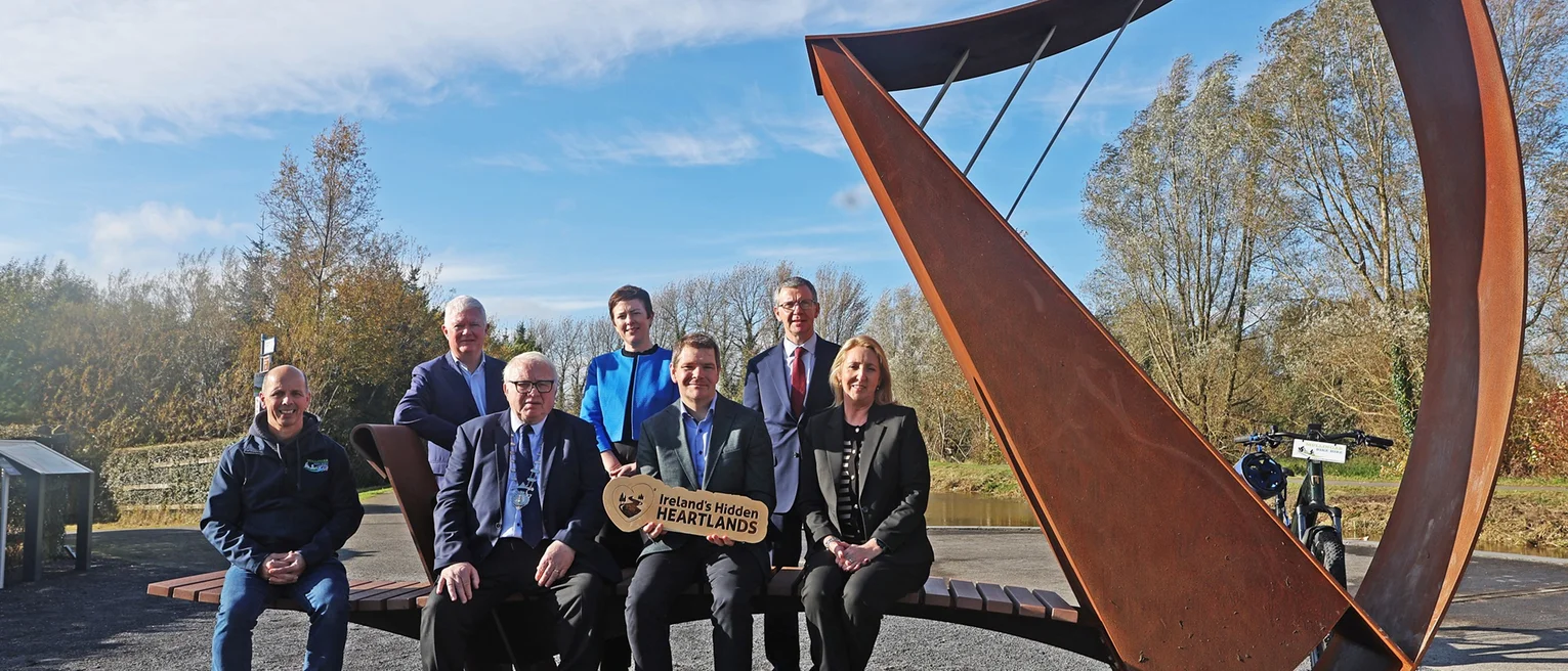 Group of people in front of a large ornamental harp on the Royal Canal Greenway, Alan Maye, Mullingar Bike Hire;Cllr Bill Collentine; Minister Peter Burke;Sharon Lavin, Waterways Ireland;John McDonagh, Waterways Ireland; Grainne Cornally, Fáilte Ireland;Barry Kehoe, Westmeath CoCo