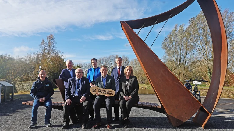Group of people in front of a large ornamental harp on the Royal Canal Greenway, Alan Maye, Mullingar Bike Hire;Cllr Bill Collentine; Minister Peter Burke;Sharon Lavin, Waterways Ireland;John McDonagh, Waterways Ireland; Grainne Cornally, Fáilte Ireland;Barry Kehoe, Westmeath CoCo