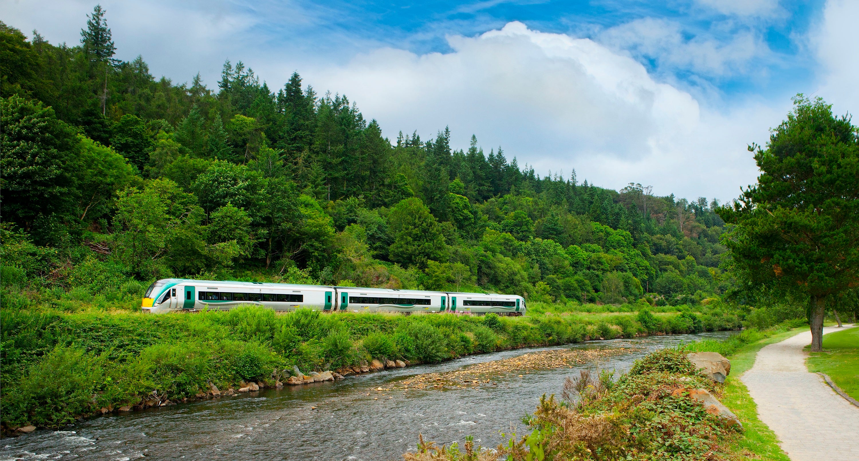 A train on the tracks by a river