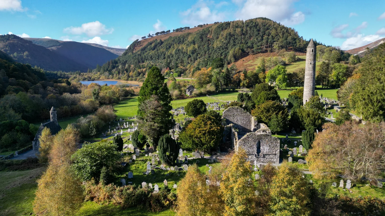 A cemetery with trees and a mountain in the background