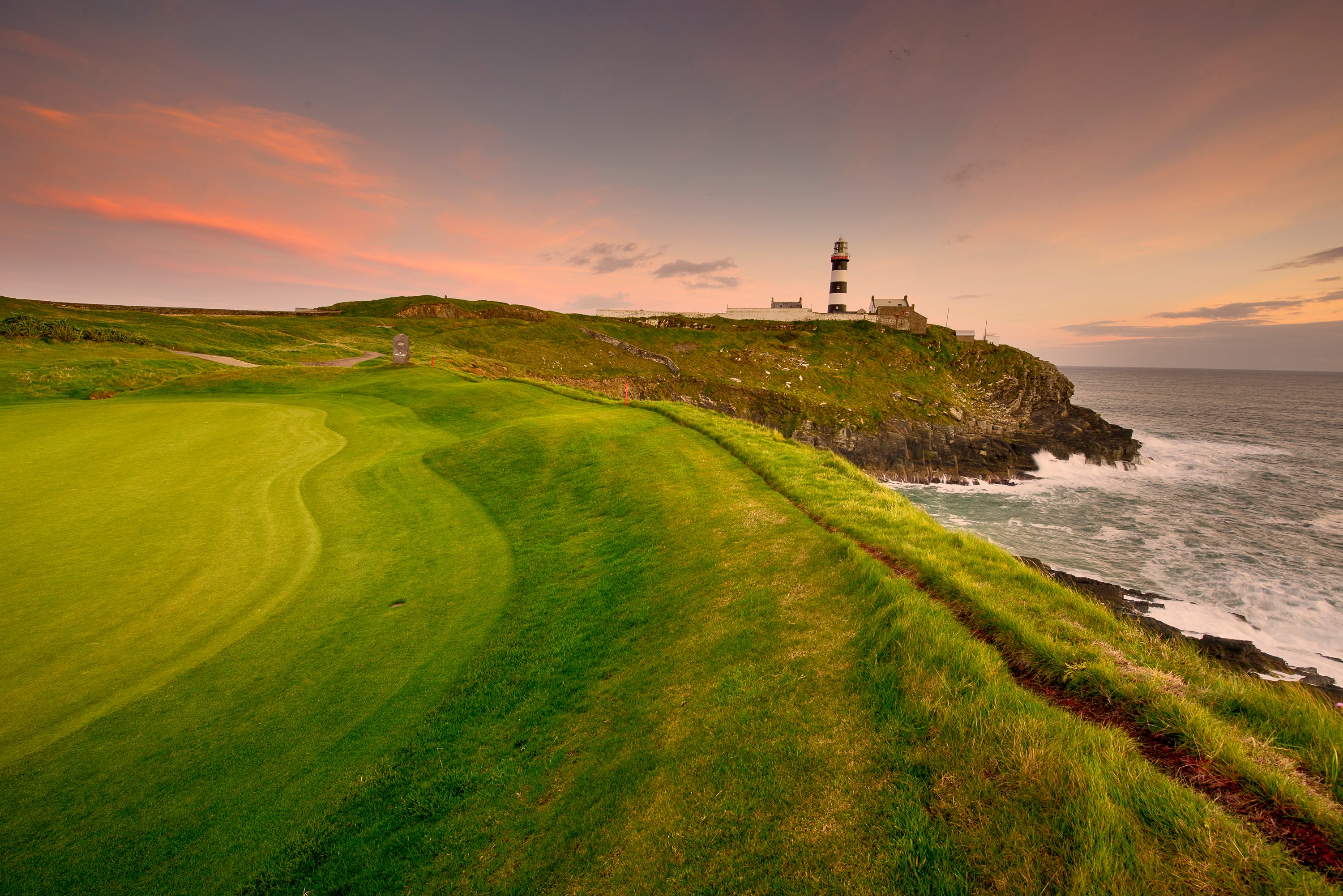 A golf course with a lighthouse on the top