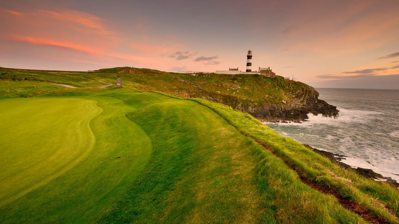 A golf course with a lighthouse on the top
