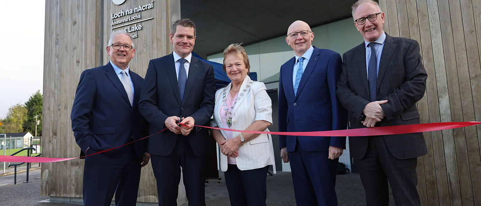 Group of people standing in front of the newly opened water sports facility in Acres Lake, Leitrim