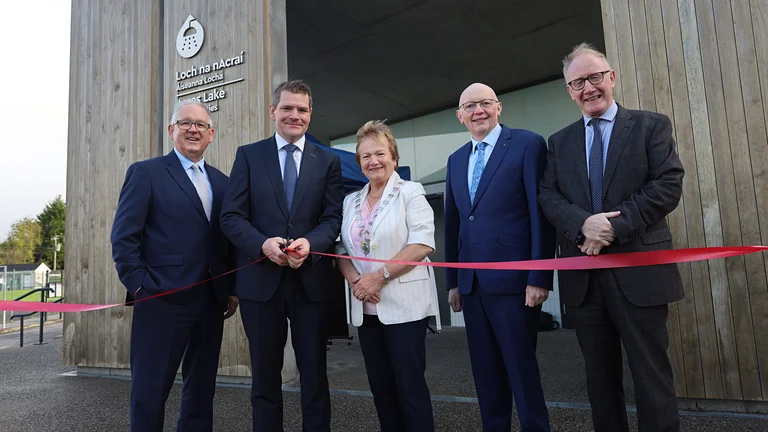 Group of people standing in front of the newly opened water sports facility in Acres Lake, Leitrim