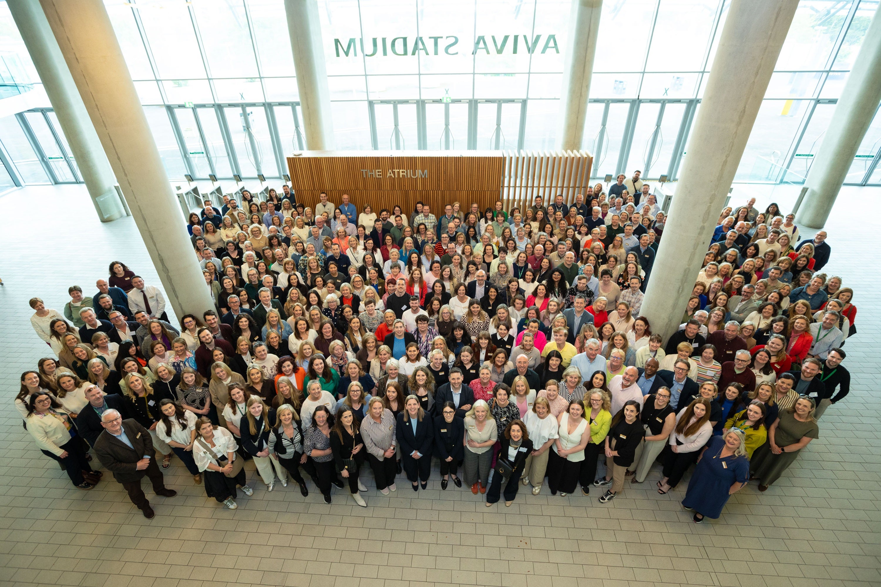 A large group of people standing in a large room