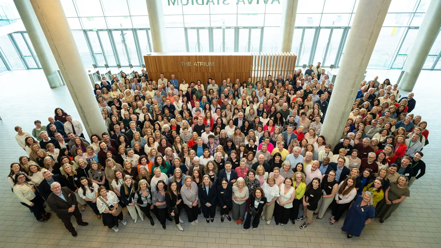 A large group of people standing in a large room