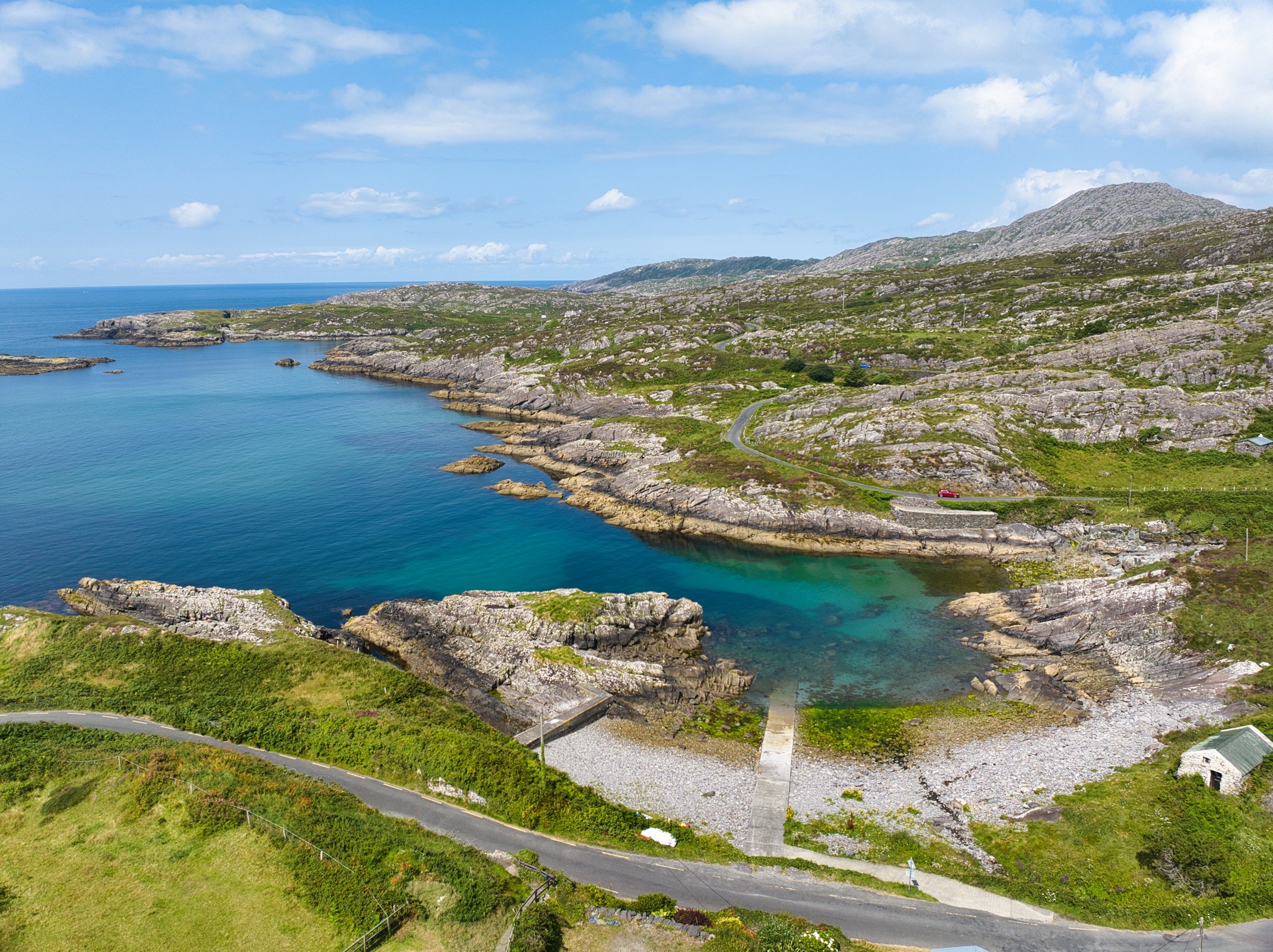 A body of water with a road and grass