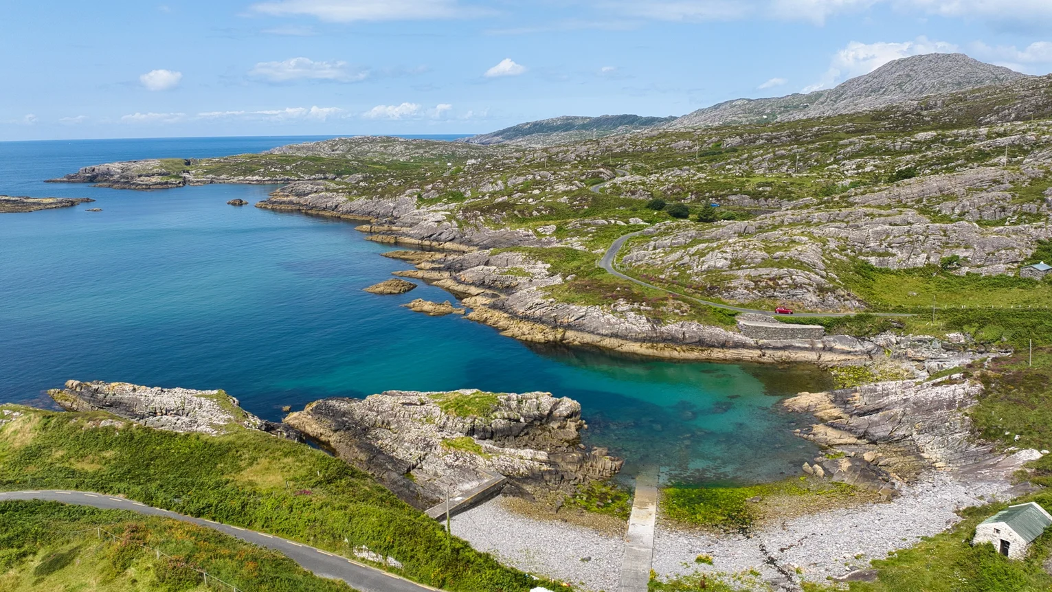 A body of water with a road and grass