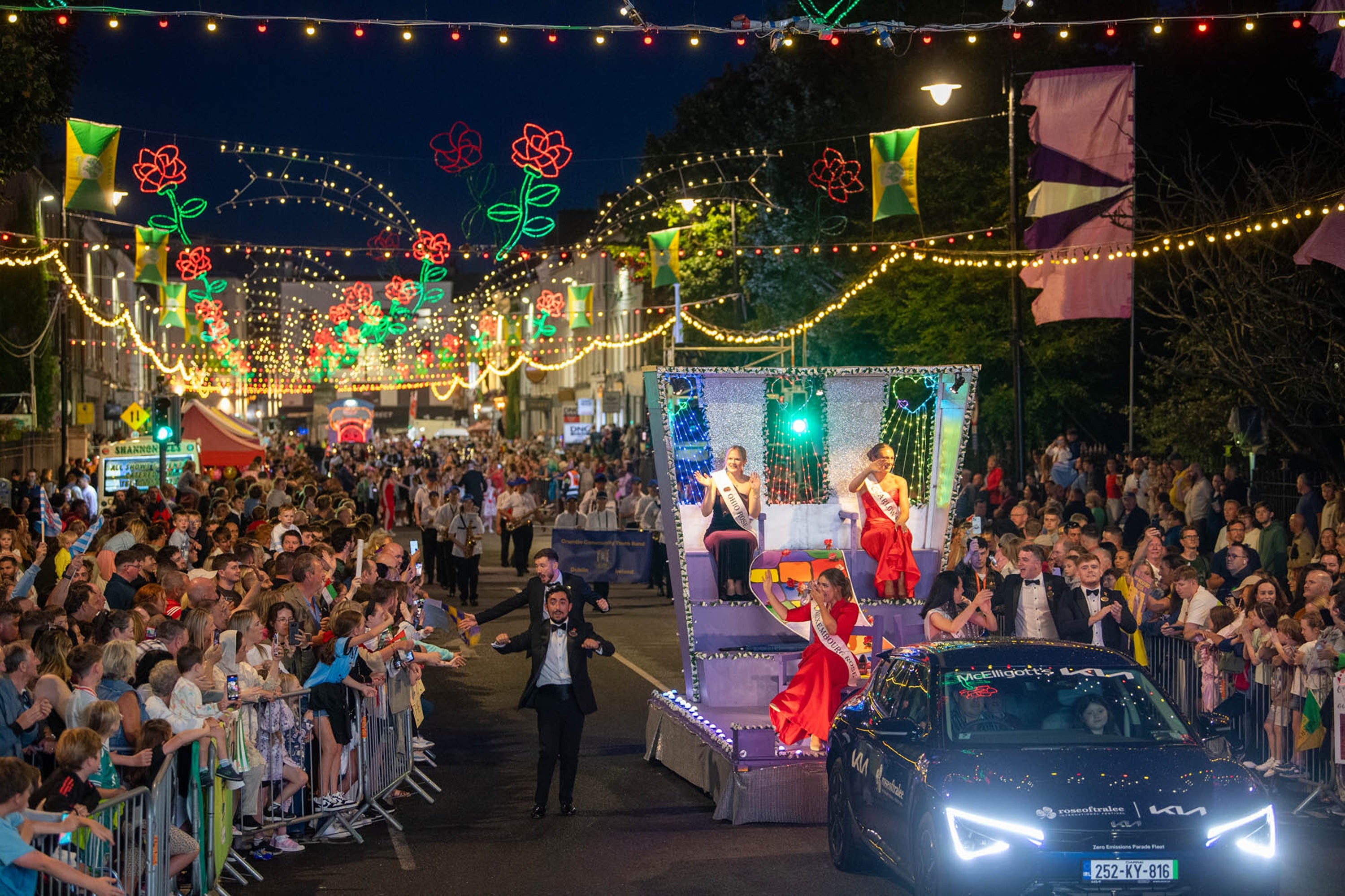 A parade with a crowd of people