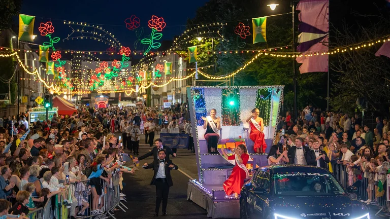 A parade with a crowd of people
