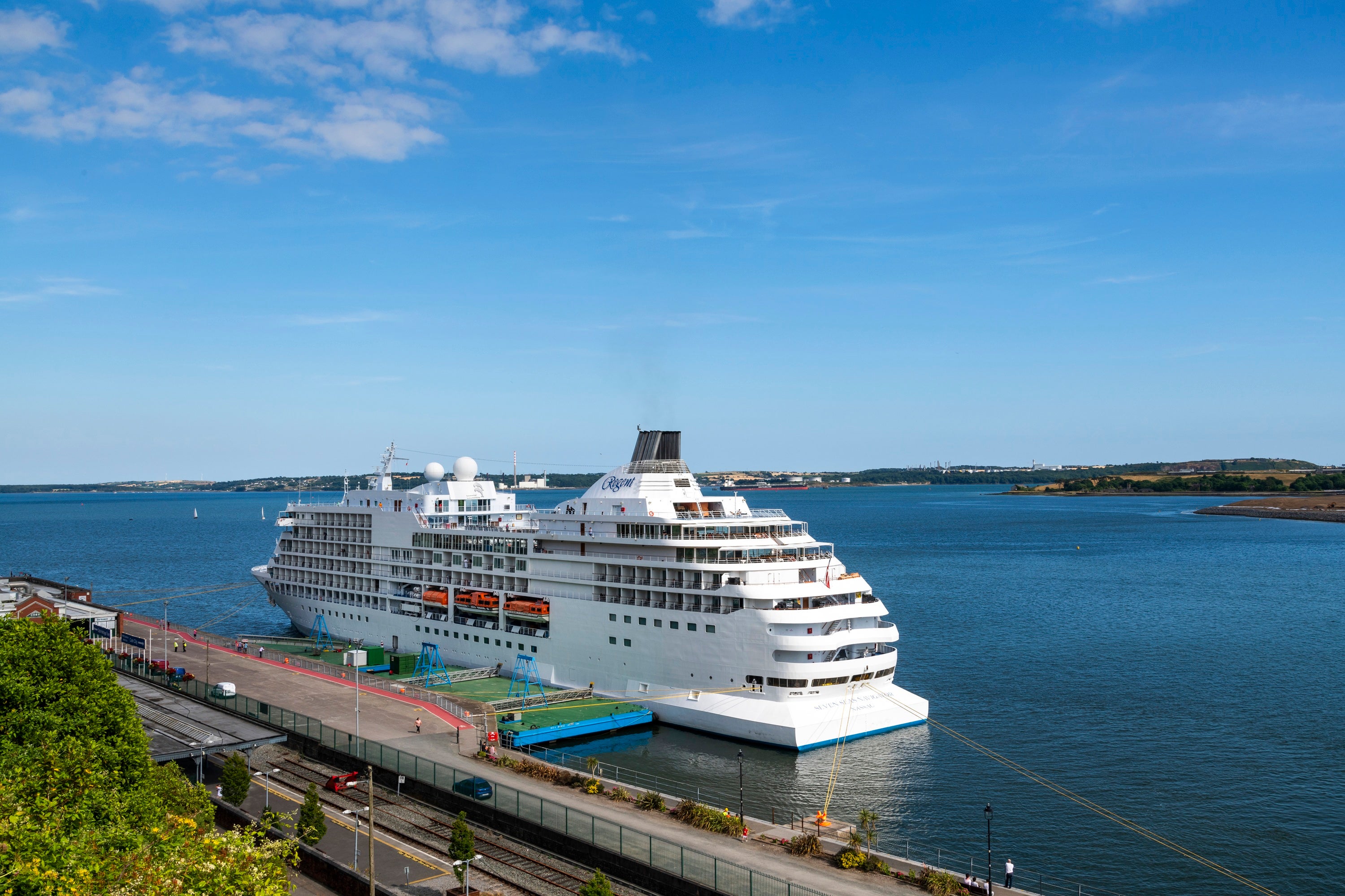 A large white cruise ship in the water