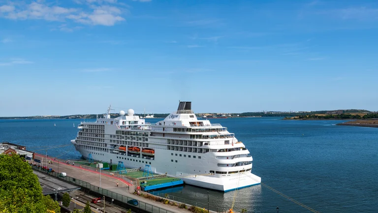 A large white cruise ship in the water